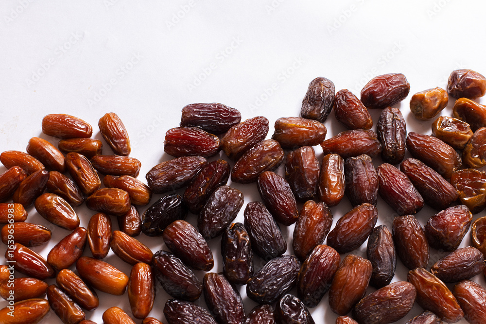 Obraz premium Assorted Varieties of Dates on White Background