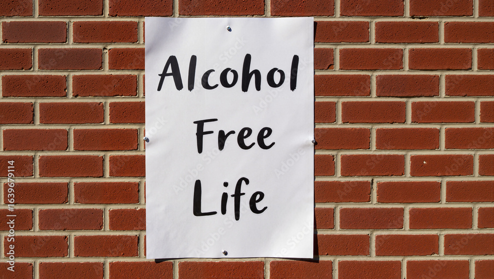 Fototapeta premium A poster titled “Life Without Alcohol” displayed on a brick wall to raise awareness about sobriety and combat alcoholism.