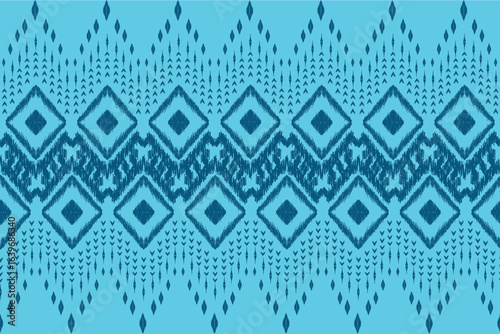 abstract seamless pattern 
The blue ikat fabric features a distinctive, handcrafted aesthetic characterized by blurred, feathered edges and intricate geometric or abstract motifs. Its signature look.