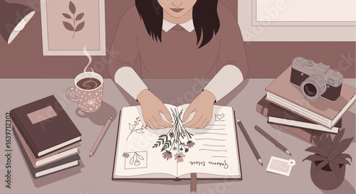 Creative artist arranging pressed flowers in journal, capturing memories