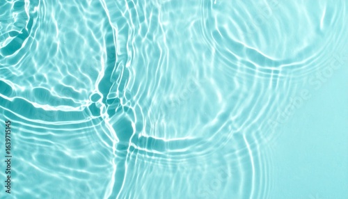 A tranquil view of rippling water, showcasing soothing turquoise hues and the play of light on a calm surface.