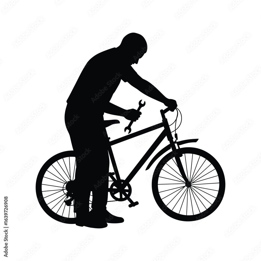 Obraz premium Silhouette of a man repairing a bicycle with a wrench bike maintenance cycling repair