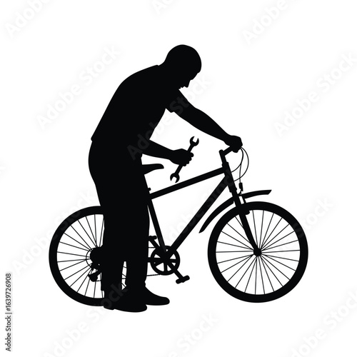 Silhouette of a man repairing a bicycle with a wrench bike maintenance cycling repair
