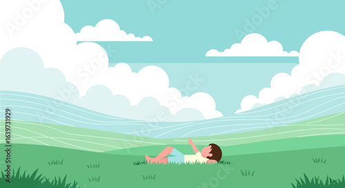 Idyllic afternoon contemplation: Boy lying in field under a summer sky