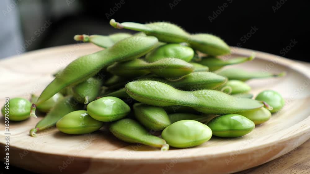 Edamame Pods on a Wooden Plate Edamame Pods on a Wooden Plate