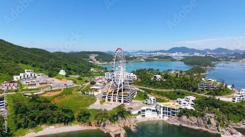 Aerial view of Yeosu Art Land in Dolsan, South Korea, featuring a Ferris wheel, resorts, and scenic southern coast