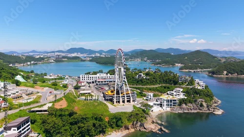Aerial view of Yeosu Art Land in Dolsan, South Korea, featuring a Ferris wheel, resorts, and scenic southern coast