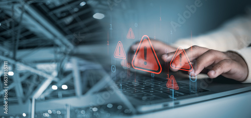 Cyber security concept, Hands typing on laptop with red cybersecurity warning icons overlay, symbolizing data breach, hacking risk, malware attack, and online security threat in digital network.