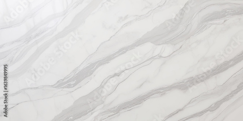 Luxury texture of light gray marble with flowing natural patterns and faint metallic highlights.	