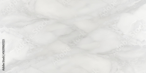 Luxury texture of light gray marble with flowing natural patterns and faint metallic highlights.	