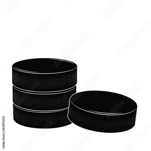 Stack of black hockey pucks and one puck beside it