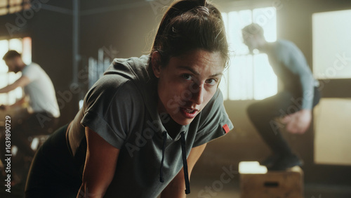 Determined sportswoman taking a break during intense workout in gym