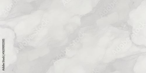 Luxury texture of light gray marble with flowing natural patterns and faint metallic highlights.