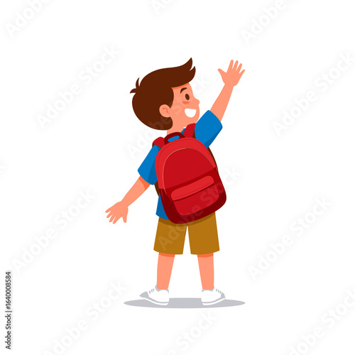 Cheerful young boy with backpack waving joyfully while looking back in a playful manner