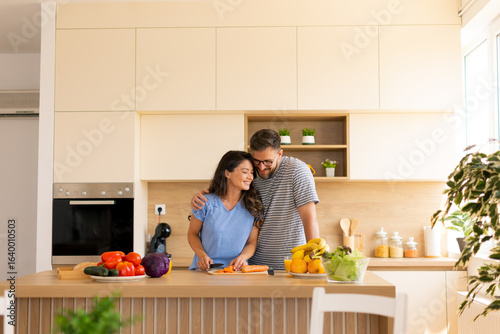 Joyful couple cooking toget...