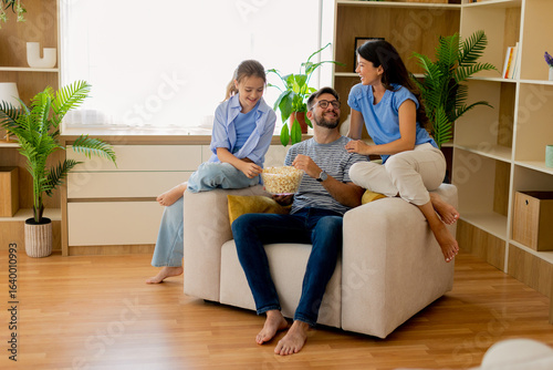 Family enjoying a cozy movi...