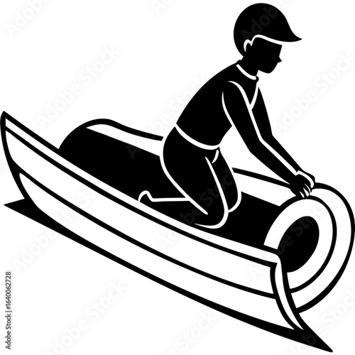 Person riding a toboggan down a snowy hill