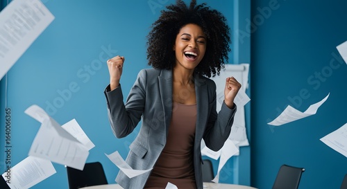 Smiling businesswomen in the Young African American woman in torn paper isolated on blue background cheering carefree and excited. Victory concept. conference room at office.
