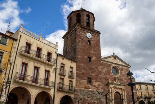 Main square of Prades with the Parish Church of Santa Maria, known as the Red Village for its reddish sandstone buildings, Tarragona, Catalonia, Spain.