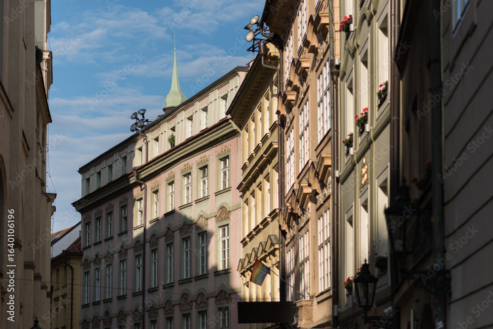 Naklejka premium old town, detailed facade of a historical building, likely in an older European city like Prague. The architecture appears to be Art Nouveau or a similar style, with ornate balconies, intricate plaste