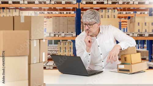 Man in warehouse managing i...