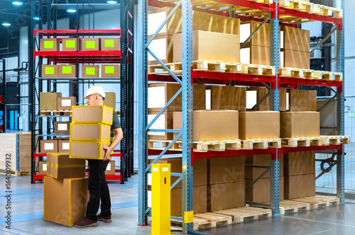 Warehouse worker in helmet ...