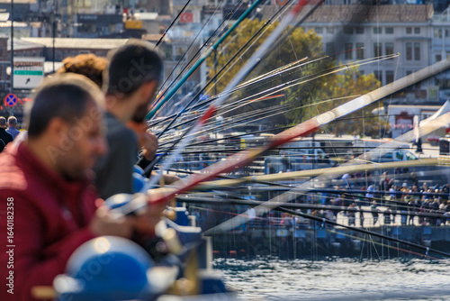 Photography Artistic blurred fishermen on Galata Bridge, popular pastime in Istanbul, Turkey