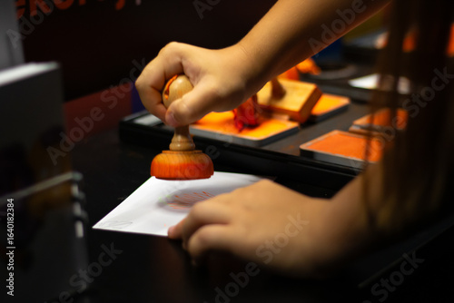 Child stamping on paper with colorful ink pads