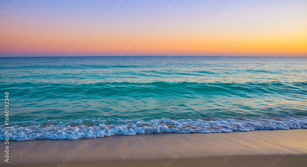 Fototapeta premium Serene beach scene featuring gentle waves under a vibrant sunset sky colors