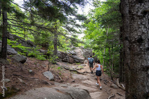 Hikers on Rocky Forest Trail in Acadia National Park Maine