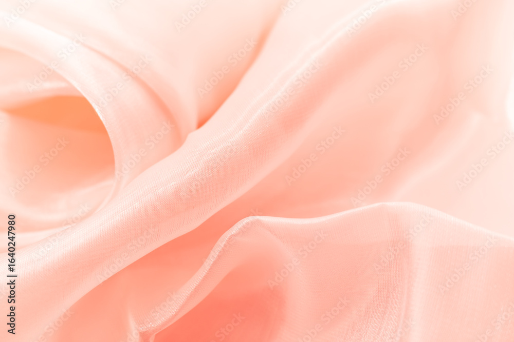 Obraz premium Close-up of soft flowing pink fabric with gentle folds and translucent texture, ideal for backgrounds, fashion branding, wellness visuals, romantic themes, and elegant minimalist design compositions