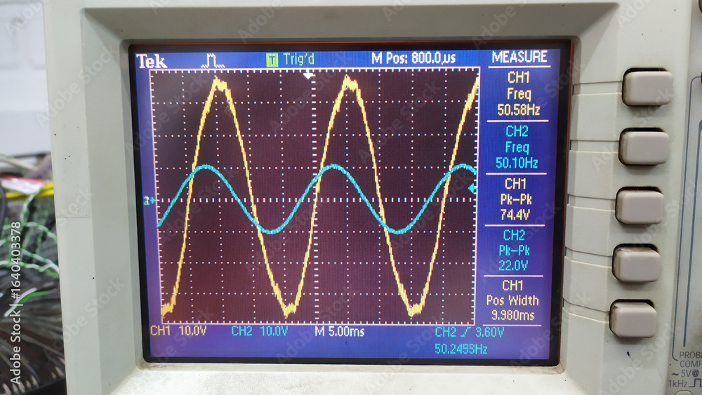 Фотография An oscilloscope output with two AC voltage waveforms