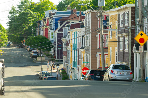 Canvastavla Colorful houses line Duckworth Street while people chat at the corner of Victoria Street, capturing the friendly vibe of downtown St