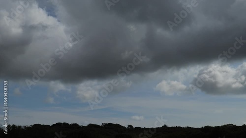 Time-Lapse of Stormy Clouds Over a Dark Rural Horizon