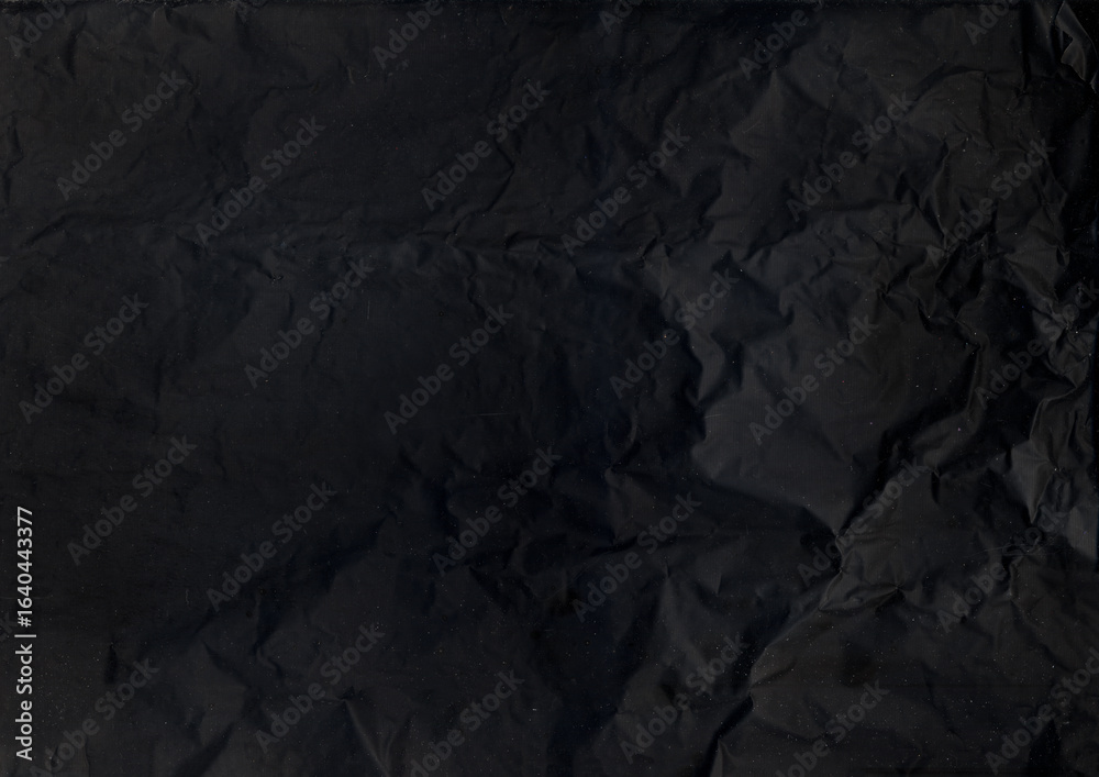 Fototapeta premium Obsolete texture. Black sheet background. Dark weathered uneven paper. Old crumpled rough art gray textile abstract defocused page.
