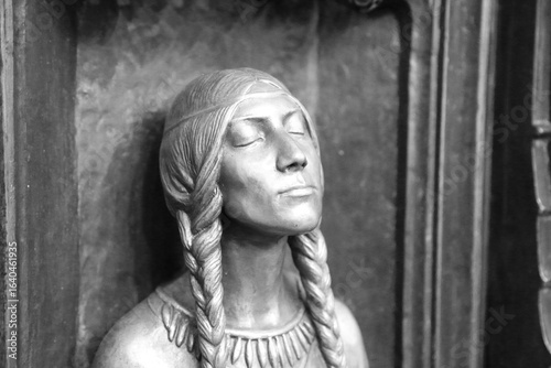 Bronze Sculpture of Native American Woman with Braided Hair in black and white