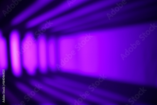 Side-view of a futuristic purple corridor with strong linear light beams creating a sense of speed and digital space. Ideal for tech concepts.