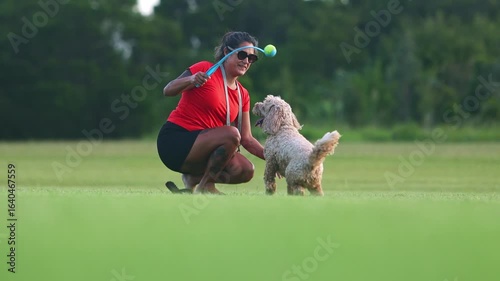 Woman playing with her dog in a park
