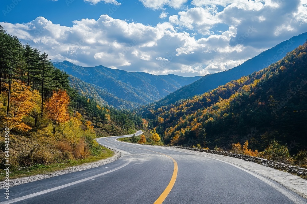 Fototapeta premium Winding road through colorful autumn mountains