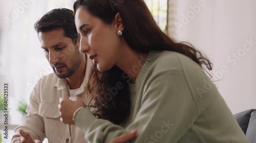 Married couple in emotional conflict and argument at home, fighting through relationship problems and difficult divorce discussions