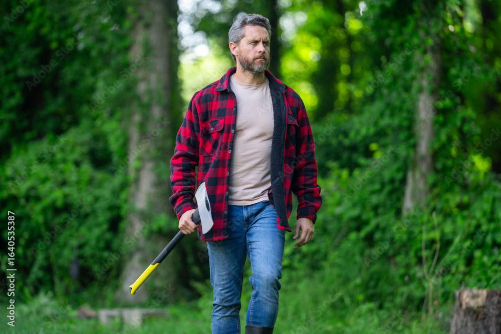 Fototapeta premium Lumberjack man with an ax in the forest.
