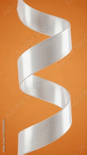 Elegant White Ribbon Spirals Down in an Abstract Fashion Over a Solid Orange Background Under Studio Lighting With Clean Presentation