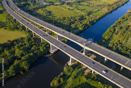Close aerial view of the M6 motorway on Thelwall Viaduct spanning the River Mersey near Warrington, showcasing the twin carriageways,