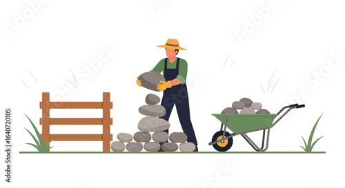 A man in overalls and a straw hat building a rock wall on a sunny day with wheelbarrow