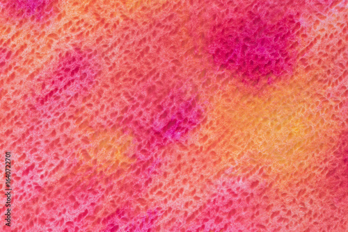 close up of cold press canvas stained with bright watercolor paints