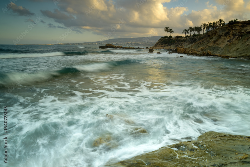 Obraz premium Cyprus Mediterranean Coastline with Turquoise Sea, Sandy Beach, and Clear Blue Sky