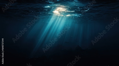Sunlight beams pierce dark underwater depths