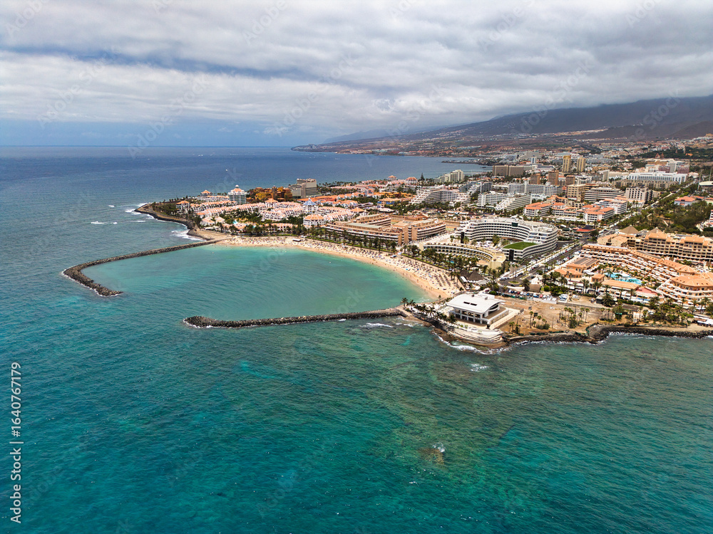 Fototapeta premium Sandy beach, city and mountains in the background, Canary Islands, aerial view