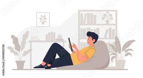 Man relaxing on beanbag chair at home using a tablet for communication or entertainment lifestyle and leisure indoor concept