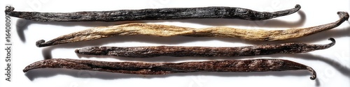 Dried vanilla pods in various stages of color